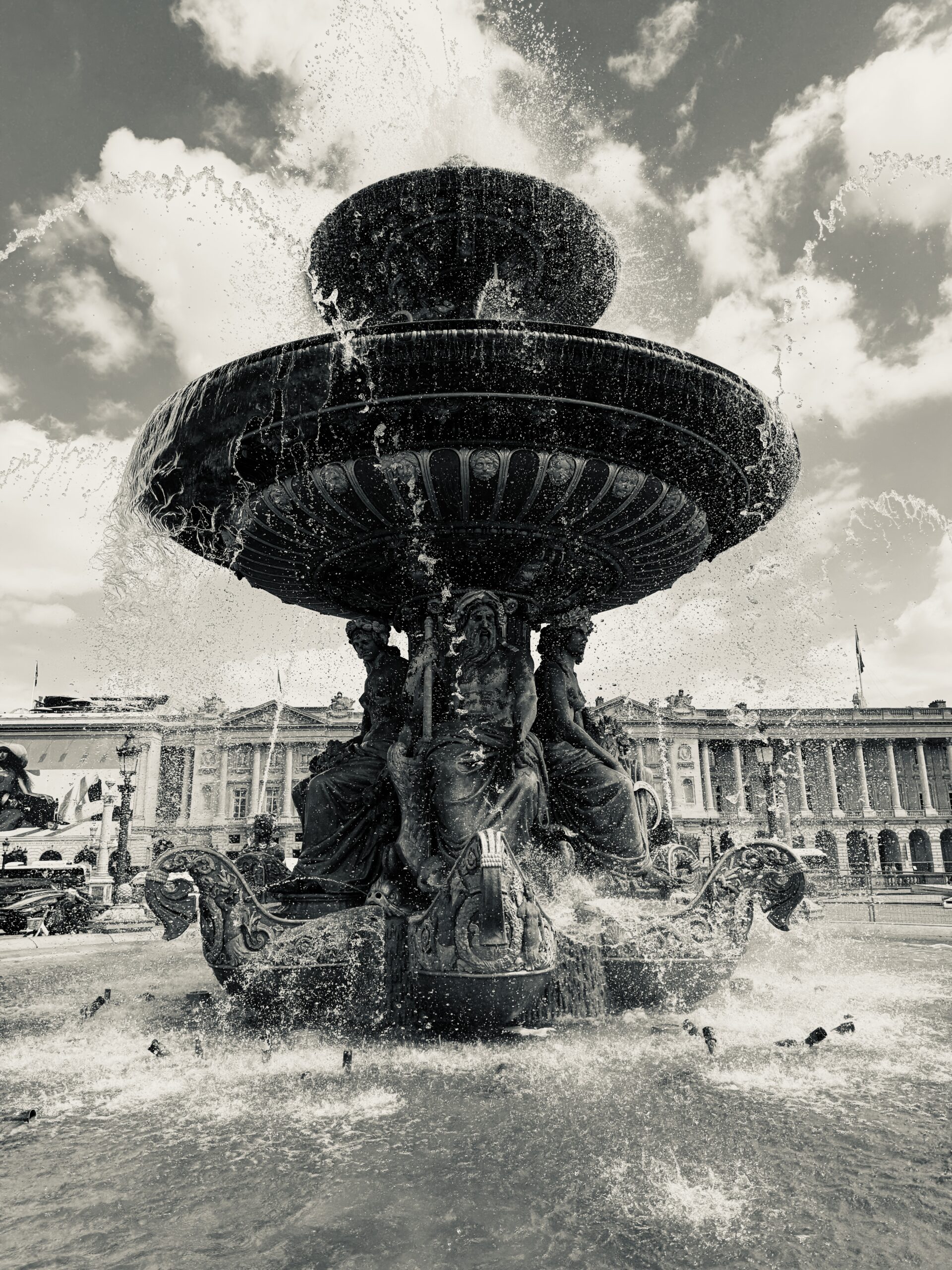 An original photograph of a Parisian fountain, illustrating natural flow and effective crowd management as used by magician and host Liam Ball.