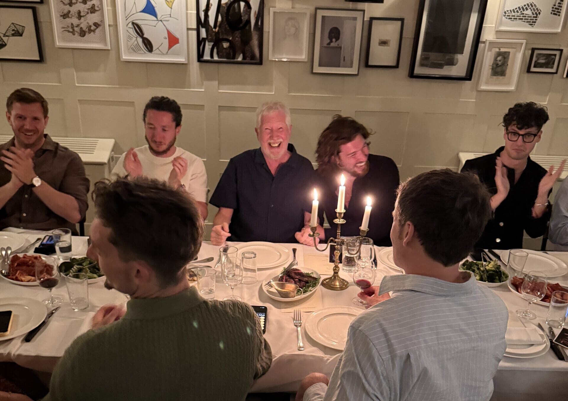 Don celebrating his 70th birthday at the head of a candlelit dining table at High Road House in Chiswick